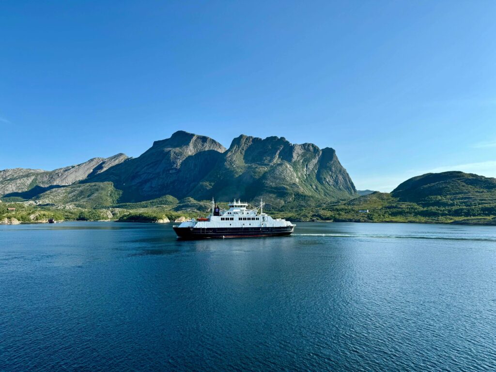 A cruise ship sailing in the ocean near mountains