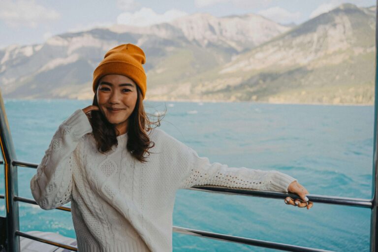 Young Woman on a Cruise with Mountains in the Background