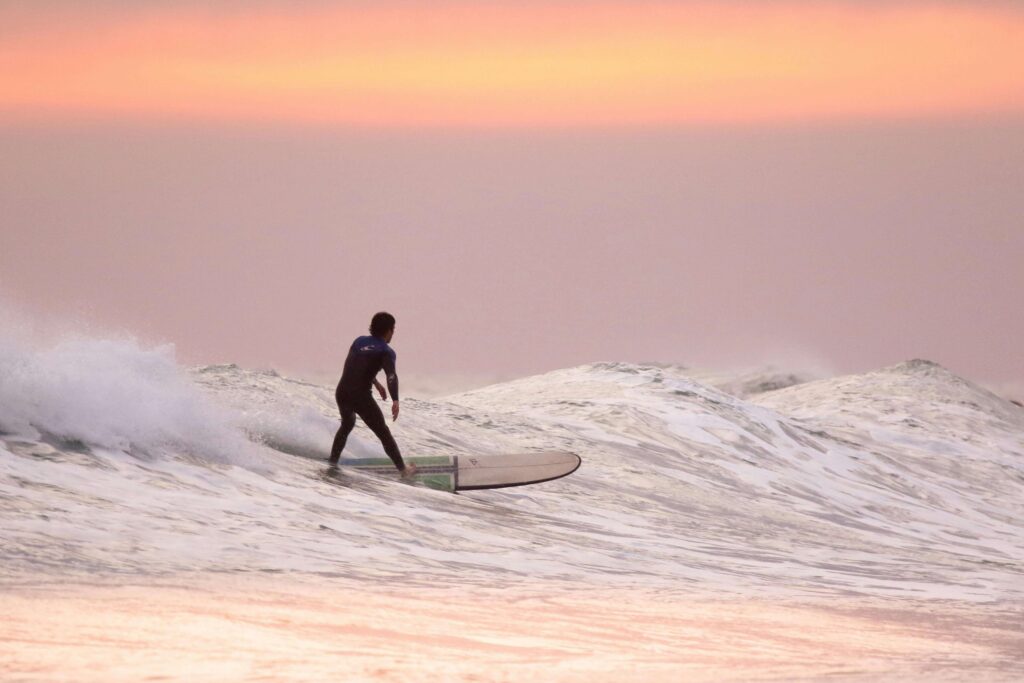 man surfing during golden hour